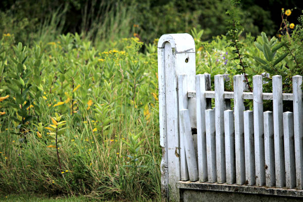 istock Vintage White Fence Post with Prairie 831540900