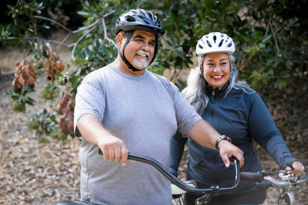 Senior Mexican Couple Biking Attractive Mexican Couple Biking fat mexican man pictures stock pictures, royalty-free photos & images