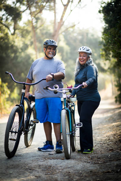 Senior Mexican Couple Biking Attractive Mexican Couple Biking fat mexican man pictures stock pictures, royalty-free photos & images