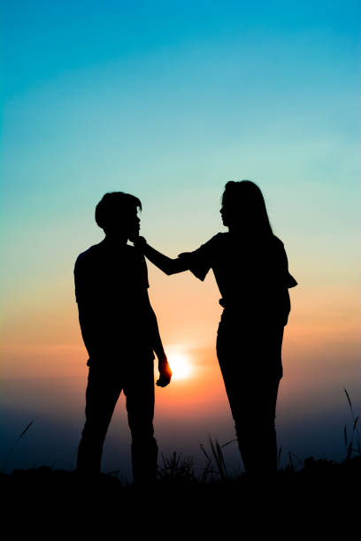 istock silhouette romantic couple on sunset. 831543512
