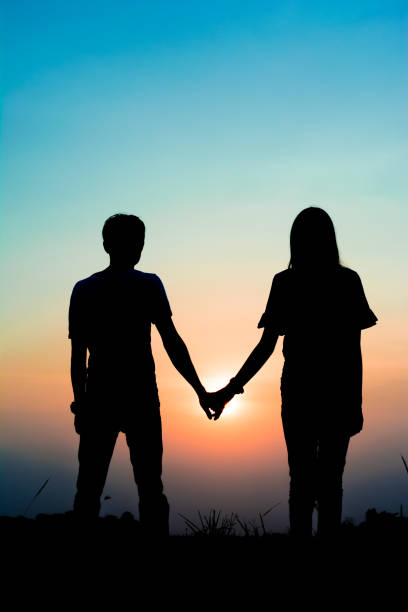 istock silhouette romantic couple on sunset. 831543540