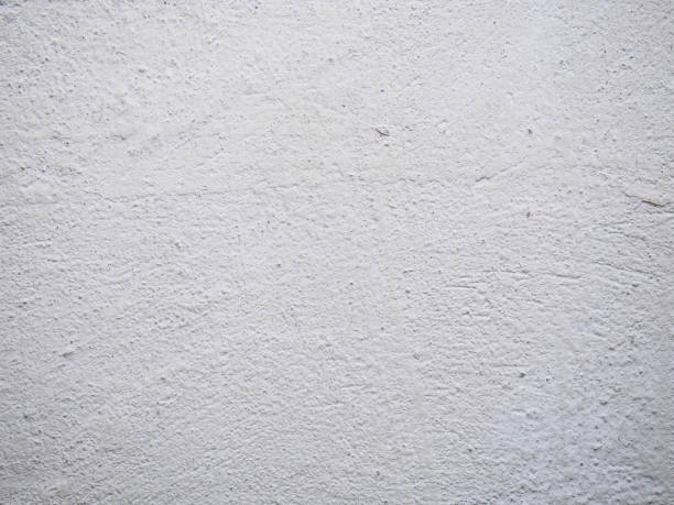 istock Texture of the putty. White plastered wall with stains and drips on a surface close-up. Macro photography colored texture of background 831543616