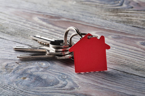 istock estate concept with key, red keychain with house symbol 831544412