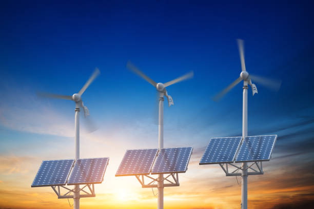 istock solar panels with wind turbines against mountanis landscape against blue sky with clouds 831547408