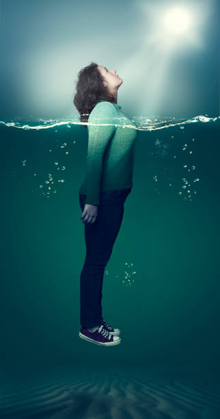 istock Young girl take out her head through water. 831547422