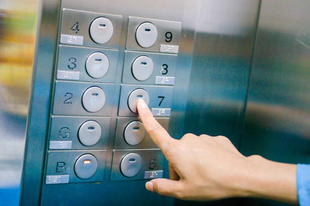 istock Women finger press number floor in the elevator 831547578