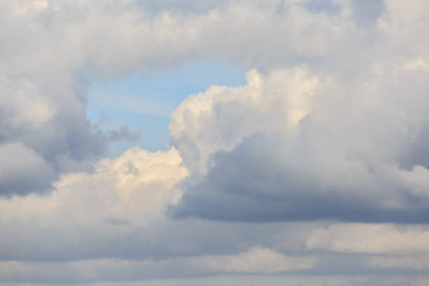 The clear blue sky break among the clouds at sunset as a background