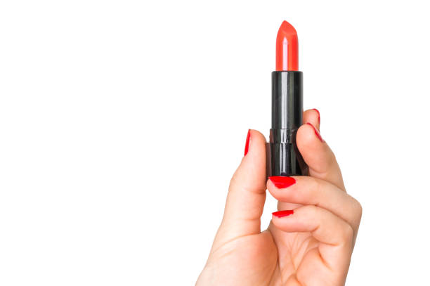 istock Red lipstick in female hand isolated on white 831557762