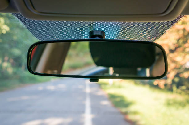 Car interior with rear view mirror and windshield stock photo