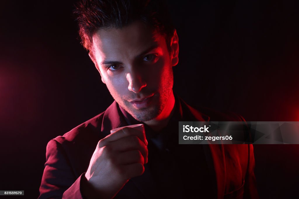 Handsome man having a coffee Handsome man having a coffee on a black background Men Stock Photo