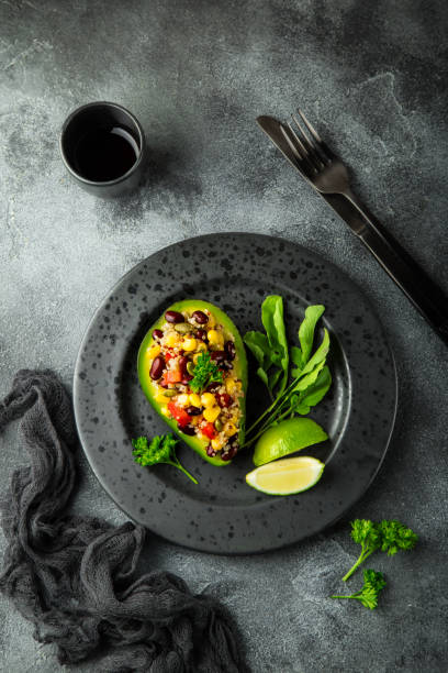 istock Avocado,quinoa,  black  bean, corn and bell pepper salad served in avocado 831559630