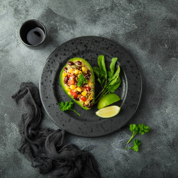 istock Avocado,quinoa,  black  bean, corn and bell pepper salad served in avocado 831559634