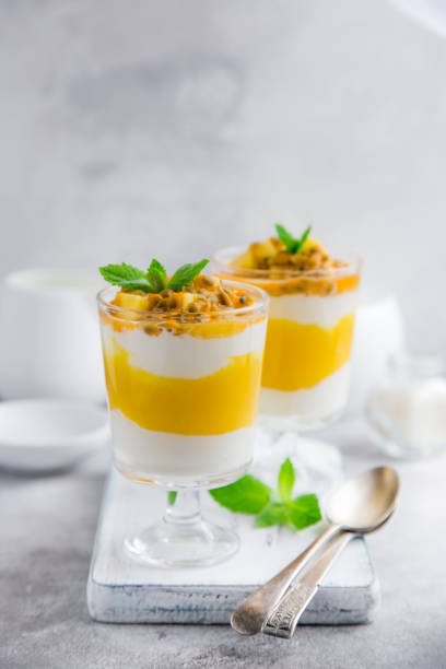 istock delicious mango,  passion fruit and cream cheese layered dessert on glasses 831559724