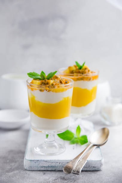 delicious mango,  passion fruit and cream cheese layered dessert on glasses delicious mango,  passion fruit and cream cheese layered dessert on glasses, selective focus trifle stock pictures, royalty-free photos & images