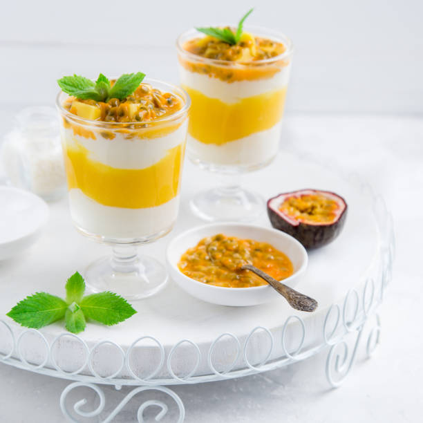 istock delicious mango,  passion fruit and cream cheese layered dessert on glasses 831559742