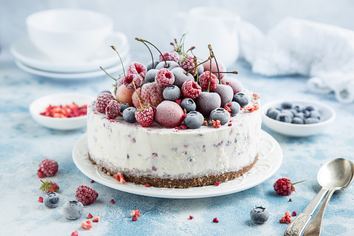 vanilla ice cream cake with frozen berries , selective focus
