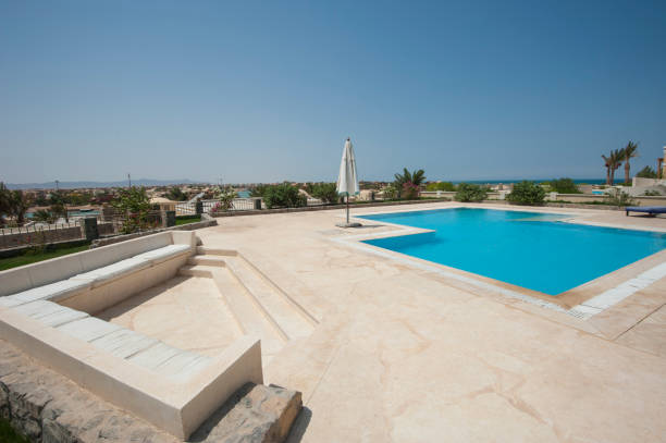 istock Swimming pool at at luxury tropical holiday villa 831566400