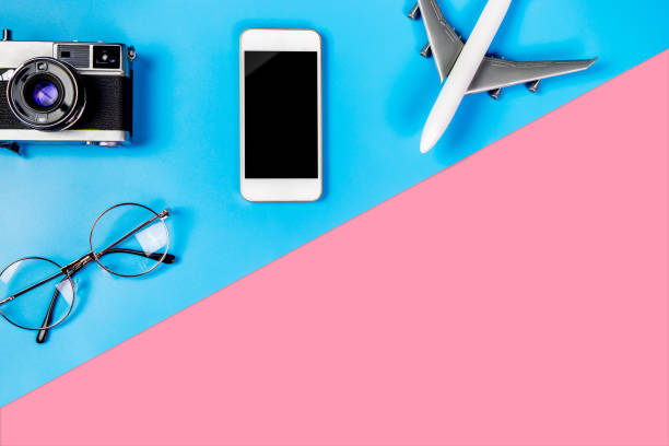 istock Smartphone with empty screen and travel object on blue and pink copy space 831566438