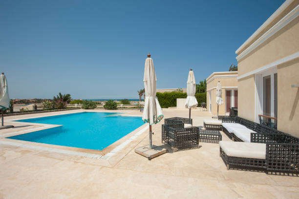 istock Swimming pool at at luxury tropical holiday villa 831566844