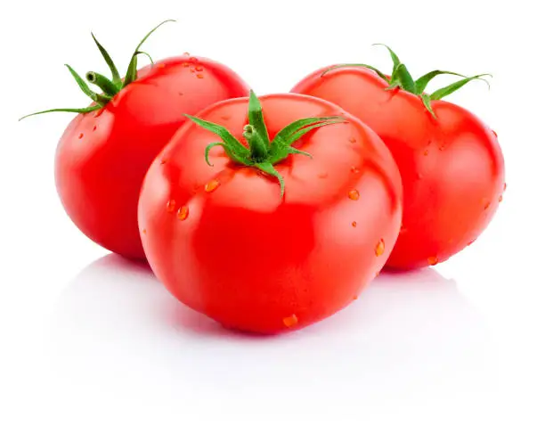 Photo of Three juicy red tomatoes isolated on white background