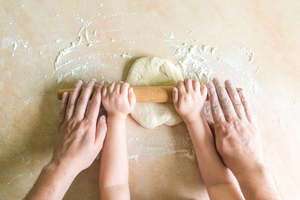 istock Children and dad hands rolled dough 831575068