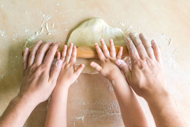 istock Children and dad hands rolled dough 831575214