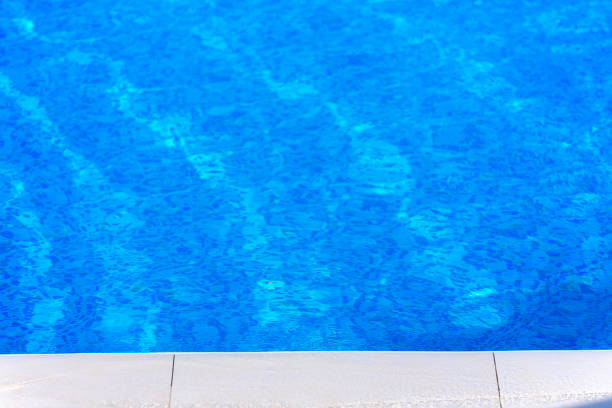 istock Rippled water in swimming pool witn sun reflection 831578580