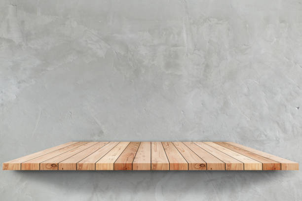 istock empty top wooden shelves with concrete wall background 831581118