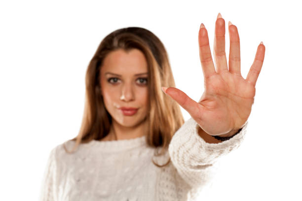 istock young woman showing stop hand on white background 831581258