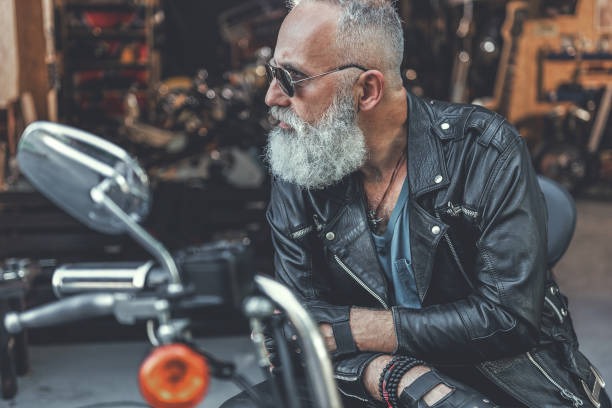 istock Stern old man ready for using motorbike 831582118