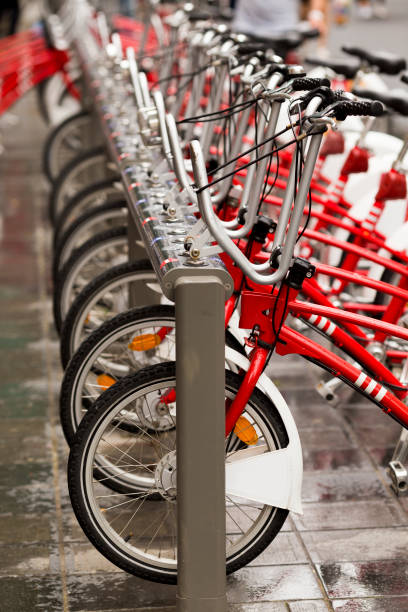 istock Front wheels of red bikes standing in a row at bicycle-sharing system 831582298