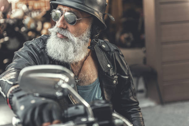 istock Serious mature man riding motorbike 831585726