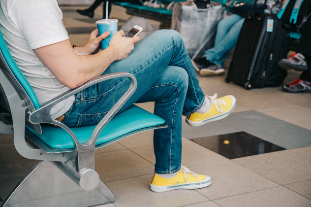 istock Young man waiting for flight at airport 831585850