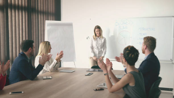 istock Businesswoman get applause from colleagues 831585960