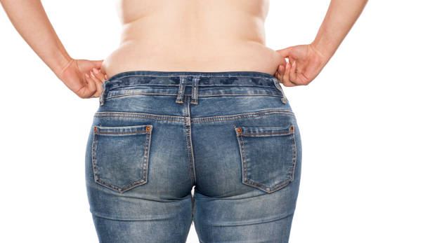 rear view of a fat woman in jeans on white background - fat layer imagens e fotografias de stock