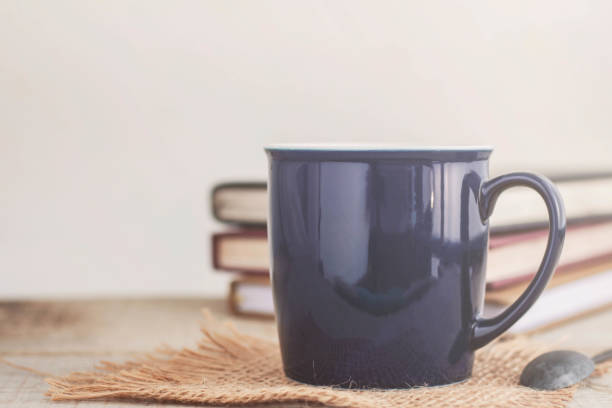 istock cup of coffee and book on wooden. 831587020
