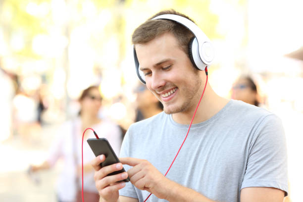 istock Boy listening to music and selecting song 831587096