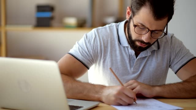 Serious student in glasses studying online from home