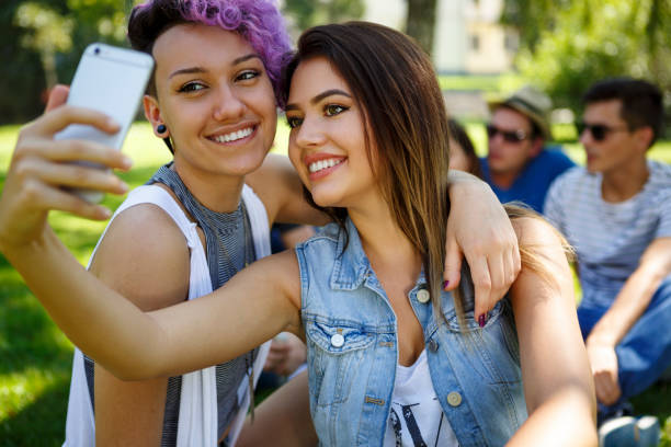 istock Two beautiful friend taking selfie 831594328