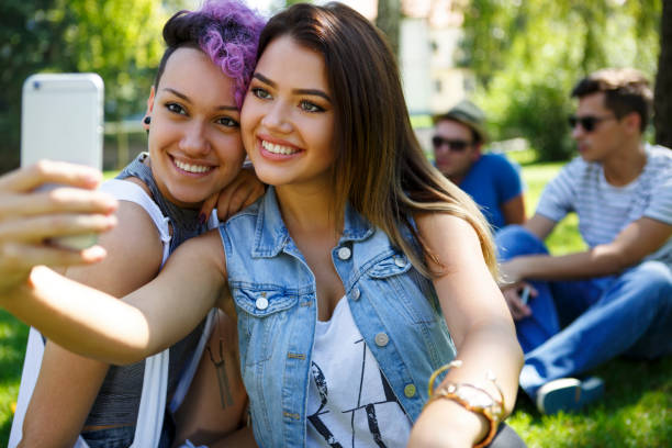 istock Two beautiful friend taking selfie 831594468
