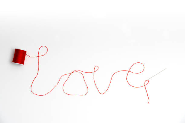 istock Love from thread in needle's eye with skein 831596796