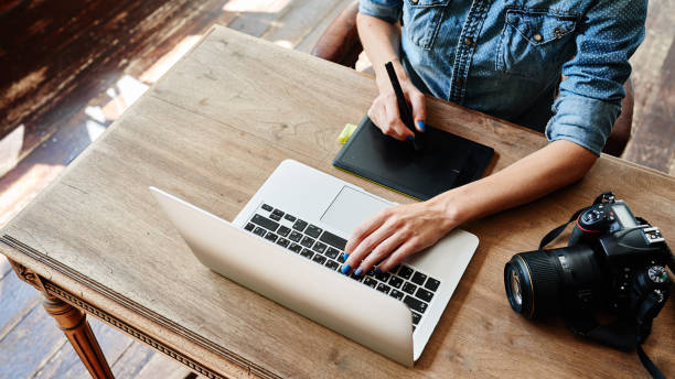 istock Photographer at work, hands on the table closeup 831598156