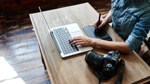 istock Photographer at work, hands on the table closeup 831598170