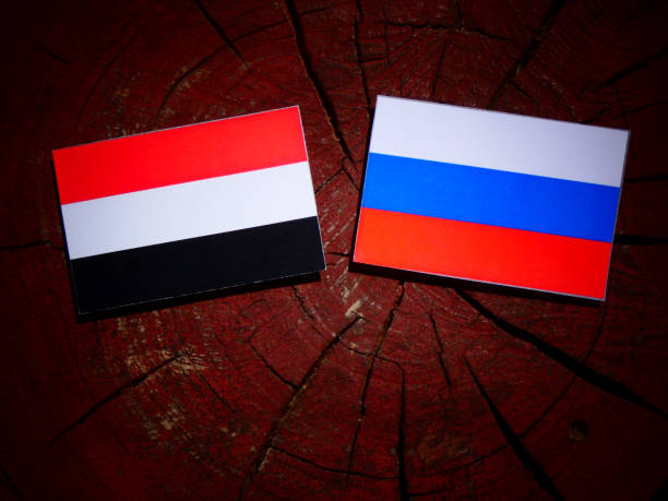 istock Yemeni flag with Russian flag on a tree stump isolated 831601962
