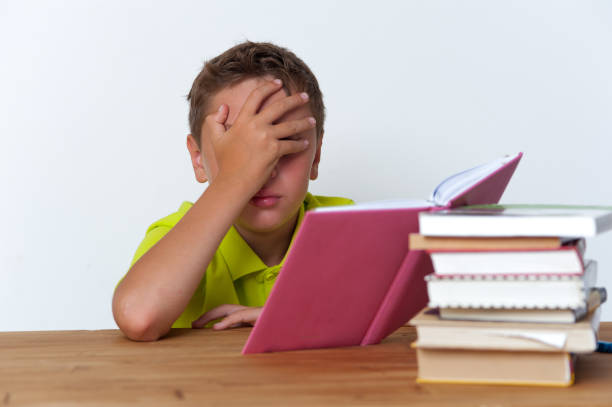 istock Portrait of tween boy reading a book 831604732