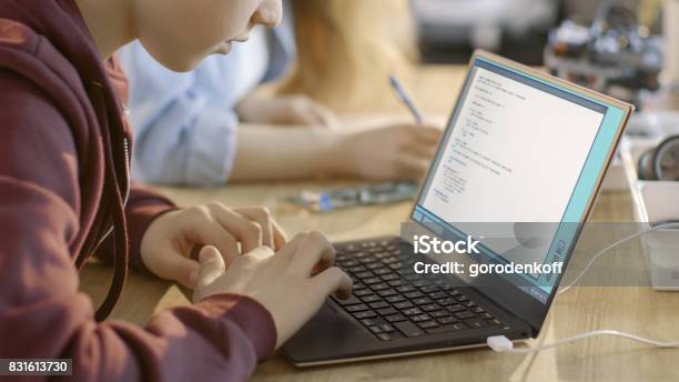 Smart Young Boy Works On A Laptop For His New Project In His Computer Science Class Stock Photo - Download Image Now