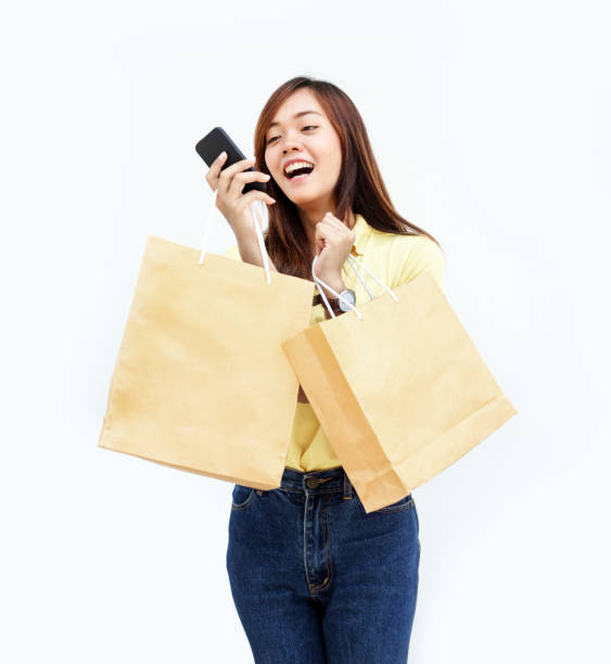 istock asian thai lady hold shopping paper bag 831614236