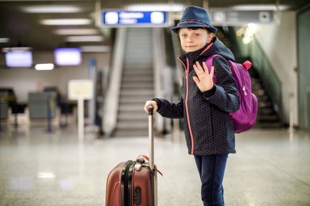 cute little girl waving goodbye at airport - separation airport child waving imagens e fotografias de stock