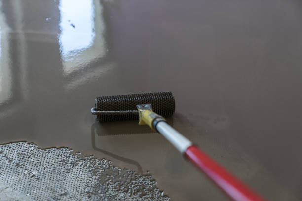 istock Mirror smooth surface of the floor. Roller application. Floor covering with self leveling plaster 831614878