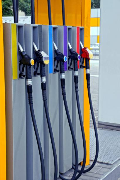 istock Hoses for pouring gasoline on a filling station column 831614900